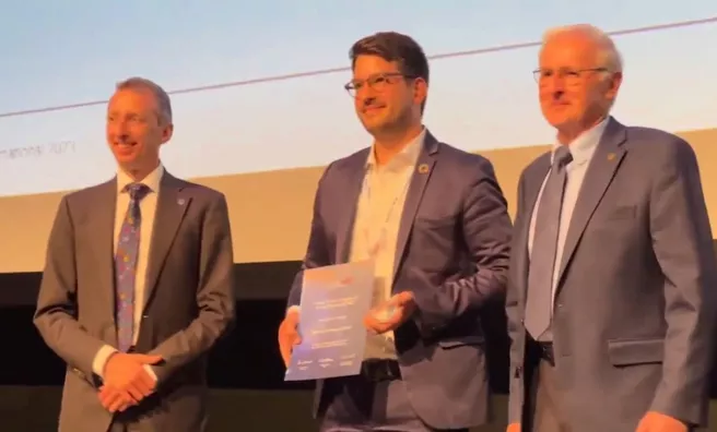 Kasimir Forth from the Chair of Computational Modeling and Simulation at the TUM School of Engineering and Design with the winning certificates for the categories "Student Research" and "Sustainability" at the award ceremony of the buildingSMART International Awards 2023
