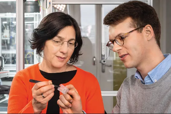 Prof. Petra Mela und ihr Promotionsstudent Kilian Müller inspizieren ein 3D-gedrucktes Gerüst