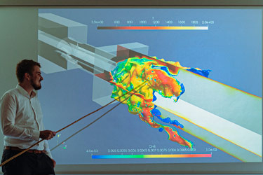 A researcher points to a simulation